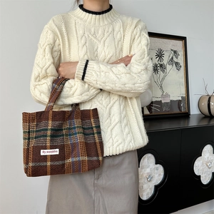 Brown plaid tweed tote bag with large capacity, worn with a cable knit sweater