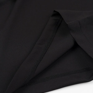 Detailed close-up of the stitching and knitted texture on a black two-piece set