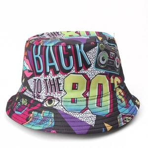 Close-up of retro 80s print pattern showing boombox and tapes on a canvas bucket hat