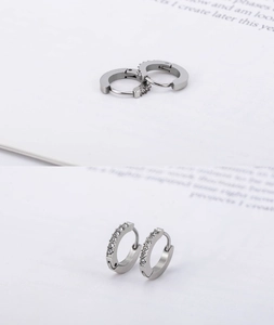 Detailed view of silver hoop earrings with clear crystals and secure clasp closure