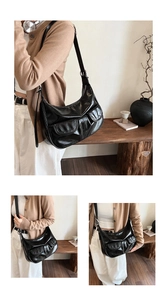 Detail of glossy black shoulder bag featuring dual front pockets and adjustable strap