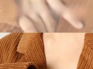 Detailed macro shot of brown corduroy fabric texture and turn-down collar on the jacket