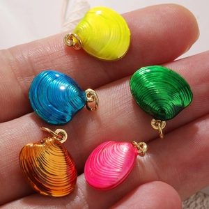 Close-up of colorful shell charms with enamel finish and gold plating for DIY jewelry
