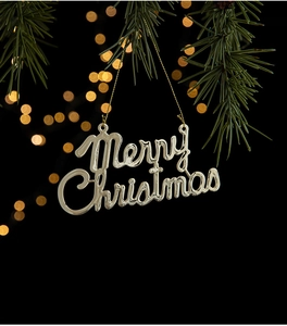Close-up of golden Merry Christmas hanging ornament with metallic finish and gold string