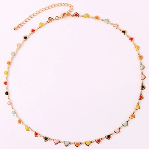 Detail view of colorful enamel heart pendants on a gold choker necklace with extender chain