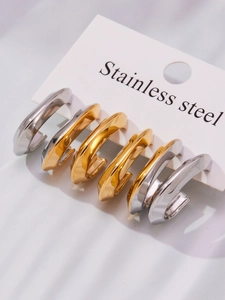 Detail of U-shape stainless steel earrings in gold and silver finish on display card