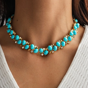 Detail of vintage double-layer necklace with turquoise stones and zircons on a model