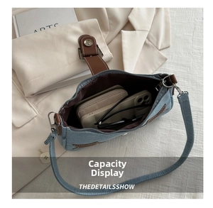 Spacious interior of blue denim underarm bag showing room for wallet, phone and sunglasses