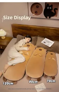 Three sizes of soft capybara long plush pillows shown in a cozy home bedroom setting