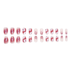 Pink and purple gradient press-on nails with white floral patterns and cat-eye finish