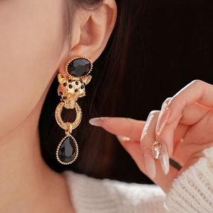 Vintage gold leopard head earrings with black drop pendants and sparkling crystal accents