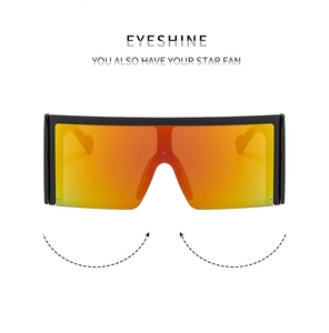Detail of oversized square shield sunglasses with orange mirror lens and wide black frame