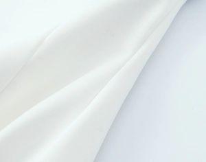 Close-up of high-density white cotton fabric showing smooth texture and fine weaving