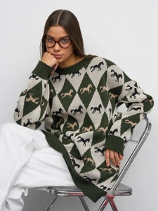 Close-up of the knitted argyle pattern with galloping horse motifs on a crewneck sweater