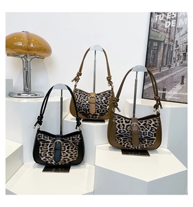 Detailed view of leopard print shoulder bags in black, camel and olive with metal buckles