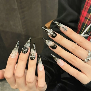 Gothic punk stiletto press-on nails with black and white marble and silver cross deco