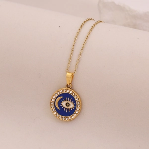 Macro shot of gold star moon necklace with blue enamel evil eye and sparkling crystals