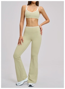Close-up of contrast white piping on light green high-waisted flared yoga pants set