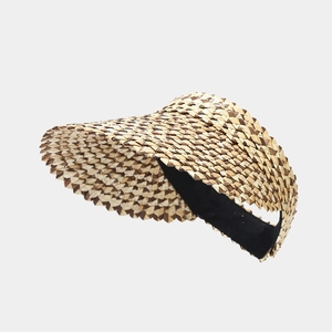 Detail of hand-woven triangular straw patterns on a summer visor hat for women
