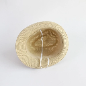 Detail view showing natural straw texture and internal white elastic chin strap on the hat