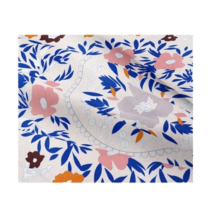 Macro detail of the floral print fabric with colorful leaves and delicate flower patterns