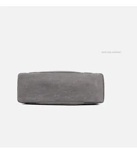 Detail view of the durable grey fabric base with reinforced stitching for the tote bag