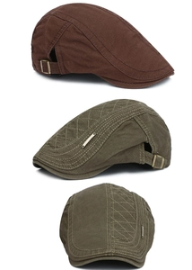 Detail view of cotton beret featuring vintage metal side buckle and textured stitching