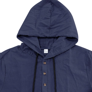 Close-up detail of dark blue linen shirt with collar label showing size L and fabric texture