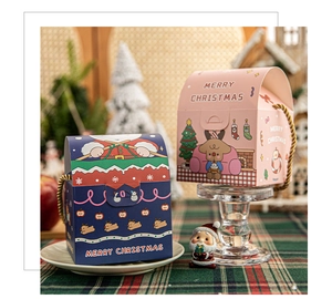 Detailed view of pink and navy Christmas gift boxes with gold ropes and reindeer patterns