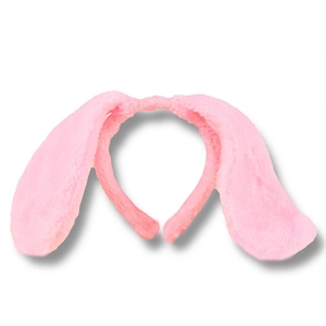 Detail view of the soft pink plush texture and drooping ears on the dog ear headband
