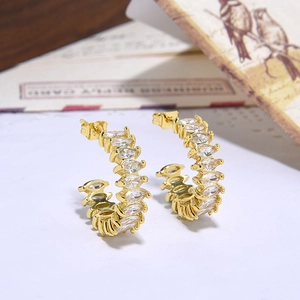 Minimalist gold C-shaped hoop earrings featuring marquise-cut cubic zirconia stones