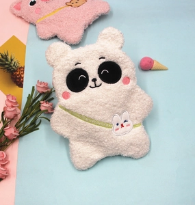 Detail of plush bear and panda pencil cases with soft fleece texture and cute embroidery