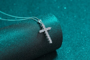 Macro detail of S925 sterling silver cross necklace with sparkling moissanite stones