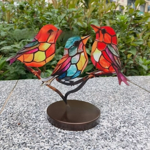 Artistic desktop ornament featuring three colorful birds perched on black branches