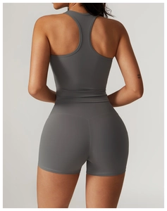 Detail of high-stretch racerback yoga top and high-waist fitness shorts in dark grey