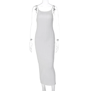Close-up of white pleated maxi dress featuring thin straps and vertical textures