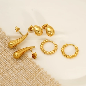 Three pairs of vintage gold bead and geometric drop hoop earrings in minimalist style