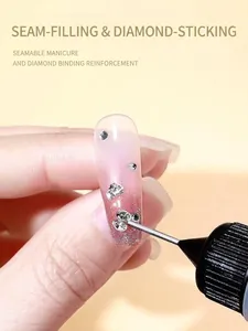 Macro shot of fine needle tip applying sealing gel to secure silver nail art rhinestones