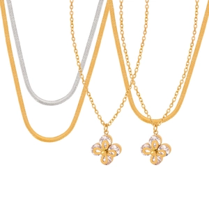 Gold and silver layered snake chain necklaces with zircon-inlaid clover pendant