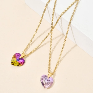 Detailed view of heart-shaped purple crystal pendant on a fine golden stainless steel chain