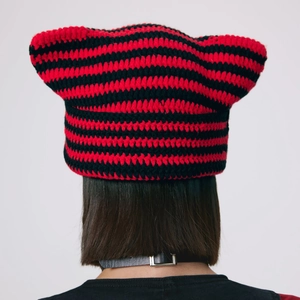 Handmade striped knit cat ear beanie in bold red and black colors for winter warmth