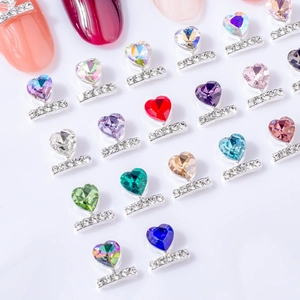 Detailed view of colorful heart crystal nail charms with silver rhinestone-encrusted bases