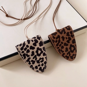 Detail of leopard print faux leather mini pouches with neck straps for glasses or keys