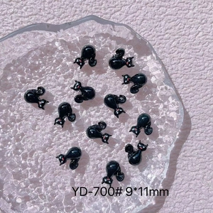 Close-up of black resin cat nail art charms with red eyes, model YD-700, size 9x11mm