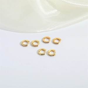 Set of three pairs of gold huggie hoop earrings with colorful pavé cubic zirconia