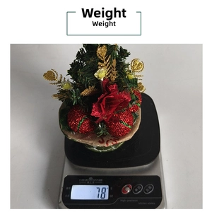 Mini Christmas tree ornament with red flowers and gold leaves weighed at 78g
