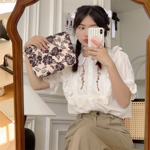 Detailed view of soft cotton floral pouch with purple vintage flower patterns and logo label