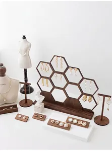 Elegant walnut wood honeycomb jewelry display stands with pearl and gold accessories