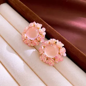 Elegant floral stud earrings with pink gemstone center and small rose petal borders