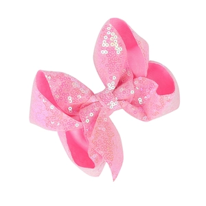 Detailed view of a 5-inch pink sequined bow hair clip with shimmering glitter finish